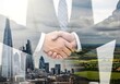 © ayesha - Double exposure of a business handshake over a cityscape and green landscape