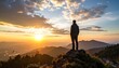 © Zee - A solitary man stands on a mountain summit, watching the golden sun rise over a breathtaking panoramic landscape