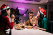 © Parichat - Asian coworkers enjoying christmas dinner party in office after work