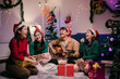 © Parichat - Friends Celebrating Christmas and Playing Guitar at Home