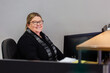 © Austockphoto - Female office staff seated behind reception desk in front computer