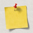 © Joko - A blank yellow sticky note pinned to a light gray surface
