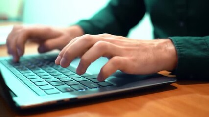 Close up hands typing on laptop keyboard