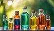 © Elliot - colorful array of glass bottles filled with liquid against blurred green background