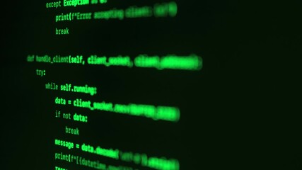 Close up of green programming code on a dark screen. Cybersecurity or hacking concept