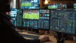 © mila103 - A sports analyst focuses intently on several monitors, analyzing data and statistics from a live football match. The setting is a high-tech office with a vibrant atmosphere.