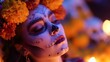 © Margarita Ratatosk - Woman with calavera face makeup and marigold flowers. Day of the Dead celebration background. Mexican holiday for remembrance and honoring ancestors.