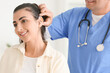 © Pixel-Shot - Male otolaryngologist putting hearing aid on woman's ear in clinic