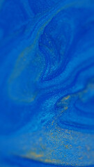 Wall Mural - Blur glitter. Liquid shimmer. Defocused blue yellow color marble texture shiny water fluid enamel floating on abstract background.