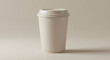 © azizah - A plain, light beige disposable coffee cup, standing upright against a neutral backdrop.
