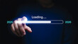 © MstKakoli - Finger presses digital loading bar with progress indicator technology concept for future data transfer