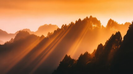 Wall Mural - Majestic sunset over misty mountains with sun rays illuminating the landscape, creating a serene atmosphere