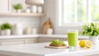 © Tenalxp - A fresh and bright kitchen scene featuring a glass of green smoothie, lemon, and avocado toast, emphasizing healthy eating and a modern lifestyle.
