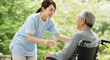 © Siti - Compassionate Caregiver Assisting Elderly Man in Wheelchair Outdoors Enjoying Nature Sunlight Happy Healthy Senior Retirement Healthcare Medical Assistance Elderly Care Support