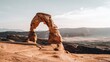 © nana - The Delicate Arch, a stunning natural rock formation in Utah, stands tall with elegant curves against a clear sky,