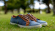 © THESUN - Relaxing blue denim sneaker with brown leather detail. stylish casual shoe sitting on green grass for an outdoor lifestyle