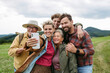 © Halfpoint - Family taking selfie on hiking trip in the nature.