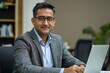 © Sameer Iyer - Confident Indian businessman in an office setup, working with a laptop and documents, managing tasks effectively in a professional environment, Generative AI