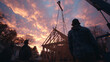 © Valena - Timber frame structure being lifted into place at sunset with workers observing the construction process