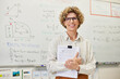 © Rido - Portrait of confident female teacher smiling at camera