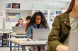 © Rido - High school students using laptop during computer class