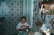 © Masson - Boy eats at kitchen table, captured in analog photography style from 1990s in Ukraine.
