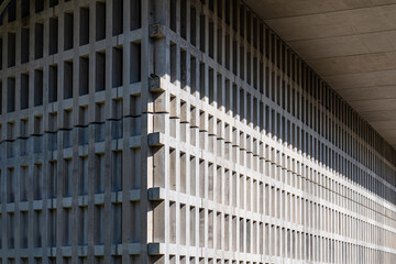 Modern architectural facade with grid pattern and shadows