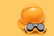 © ADDICTIVE STOCK - Hard hat and goggles on orange background
