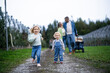 © ADDICTIVE STOCK - Family stroll in an apple orchard