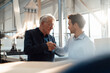 © Westend61 - Businessmen shaking hands together in factory