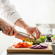 © ma--photo - A dynamic and professional shot of a chef's hands preparing food in a restaurant kitchen