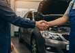 © ArtxPremium - Two people shaking hands in front of a car with the hood open, symbolizing a business agreement.