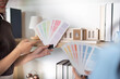 © wichayada - Color Palette Selection. Designers choosing colors for a project in a creative workspace.