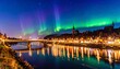 © Aldi - Nighttime aurora borealis over a river town