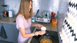 © chekart - Pretty woman cooks an omelet with mushrooms and vegetables in the kitchen. A student is salting a vegan dish in a frying pan