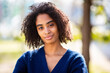 © mimagephotos - Close up portrait African American woman wearing blue sweater