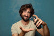 © kues1 - young adult bearded man with a soap dispenser