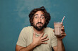 © kues1 - young adult bearded man with a chocolate milkshake