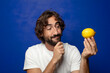 © kues1 - young adult bearded man holding a lemon