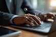 © ANINDITA - Businessman using laptop with shopping cart icons, representing online shopping and e-commerce.