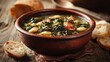© fivan - A rown ceramic bowl of butter bean and kale stew, rustic torn bread on side, olive-toned surface with subdued color grading