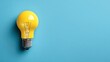 © netsay - Vibrant Yellow Paper Light Bulb Illuminating a Serene Blue Backdrop Ideal for Branding and Creative Projects, Boosting Positivity and Energy.