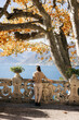 © Doralin - Tourist enjoying lake como view from a balcony in autumn