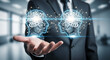 © Inspire Shots Hub - A hand displays two digital heads, gears inside, connected by network lines, symbolizing AI collaboration, communication, and synergy in business