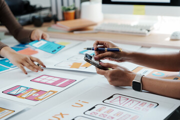 Wall Mural - web designers are creating user experience ux design for mobile application and using a smartphone a