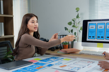 Wall Mural - two web designers working together in the office, developing user interface and user experience for 