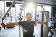 © Serhii - Man doing rehabilitation exercises with pectoral machine in gym