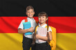 © New Africa - Children with backpacks and notebooks against flag of Germany. Language school