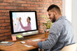 © New Africa - E-learning concept. Student having online video chat with teacher via computer at desk