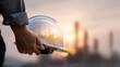 © ryker - Worker holds safety helmet with double exposure effect showcasing industrial landscape at sunset. image conveys sense of dedication and safety in workplace
